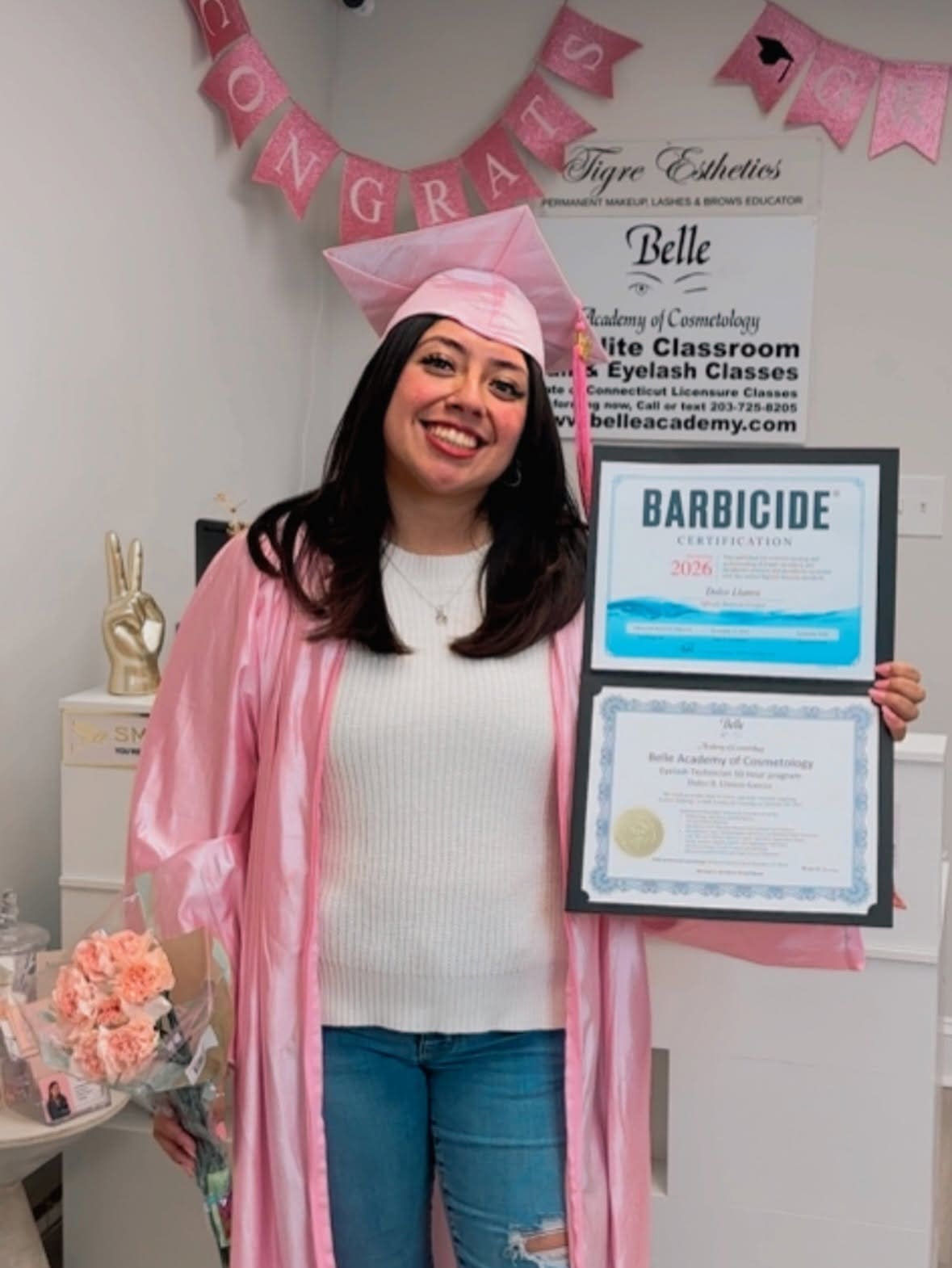 Smiling Belle Academy graduate with Barbicide certification