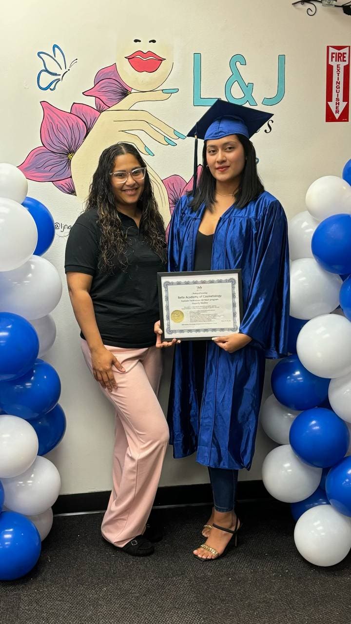 Graduate in blue gown holding certificate at Belle Academy