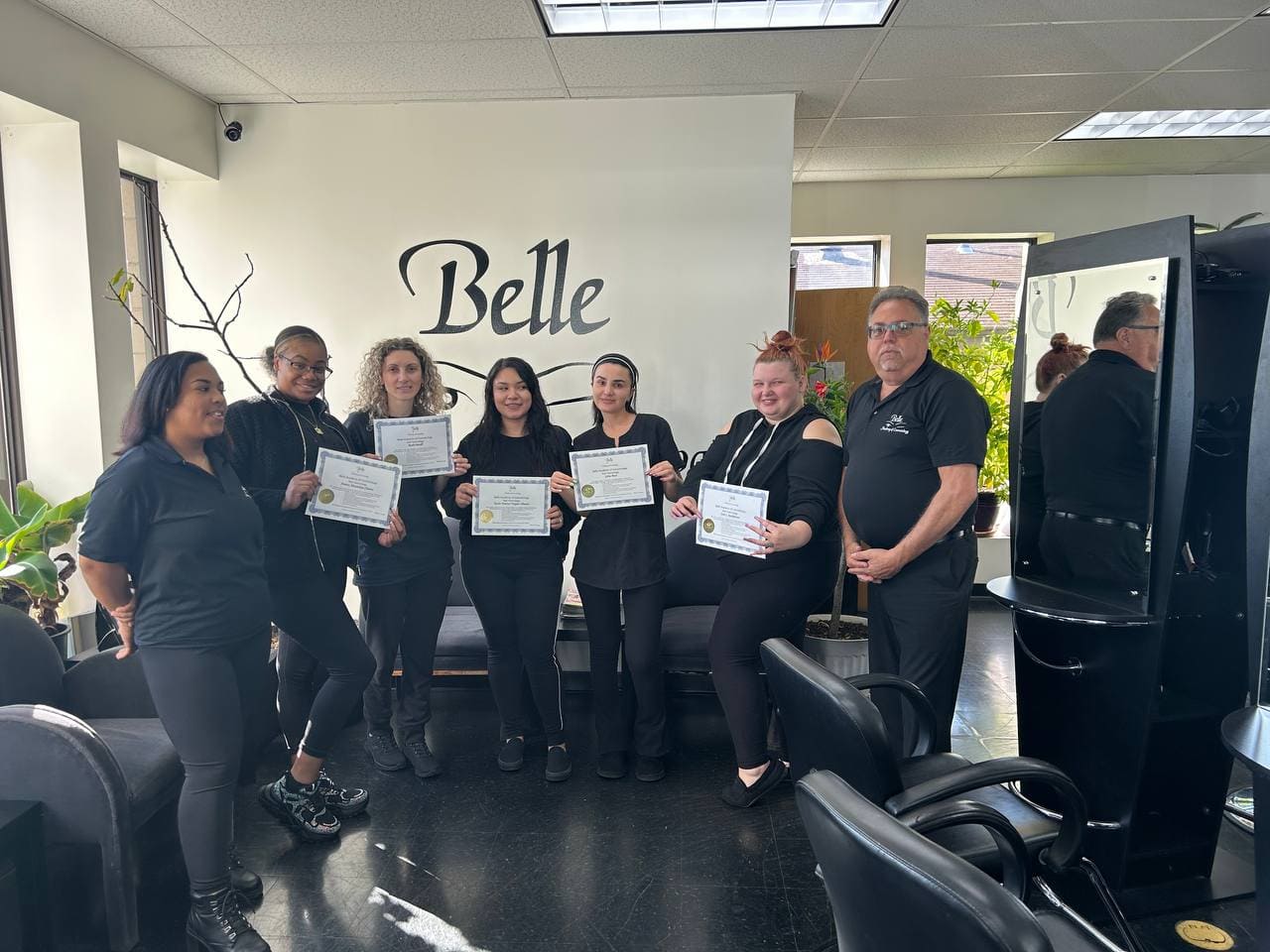 Certificate ceremony group photo at Belle Academy wall