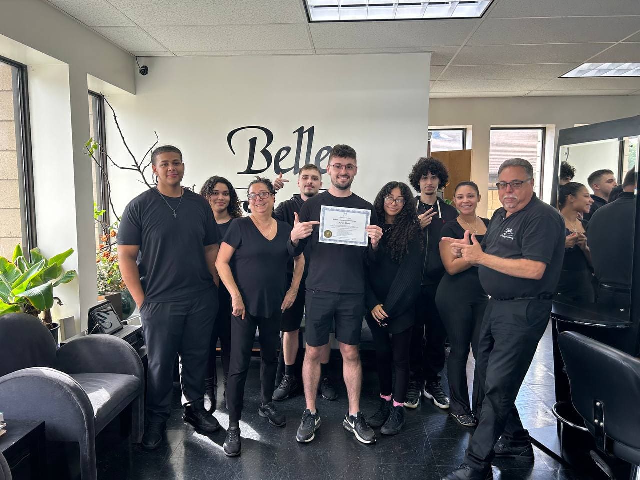 Belle Academy graduation class group in front of Belle wall